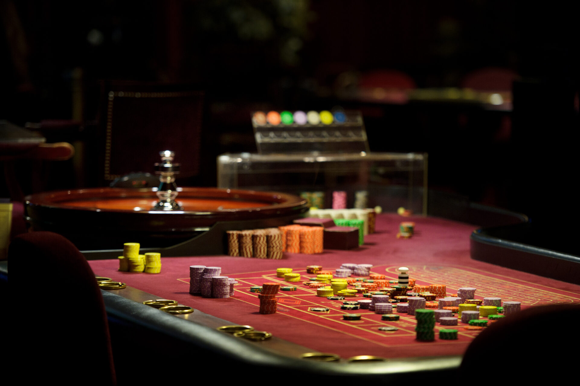 close-up chips and roulette at the casino on the red table.