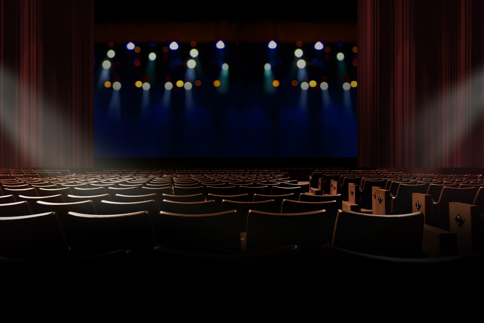 empty seat in vintage auditorium or theater with lights on stage.